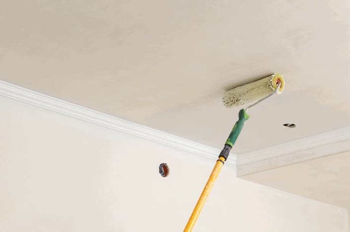 Ceiling being painted with a roller