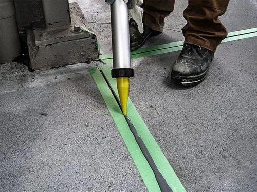 Sealant being applied into a concrete joint